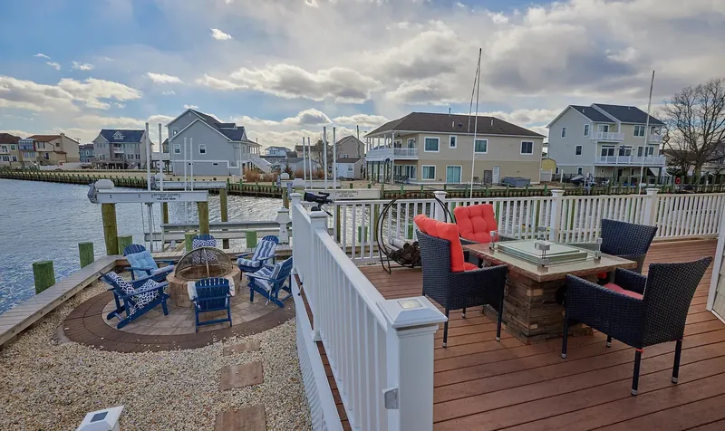 Wraparound deck with a fire pit above the bay